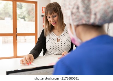 Two Dentist Women Talk To Each Other At The Dental Clinic