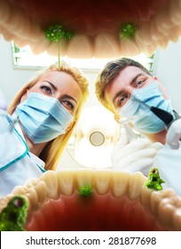 Two Dentists Examining Teeth, View From The Inside Of The Mouth 