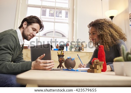 Two Designers Having Creative Meeting In Modern Office
