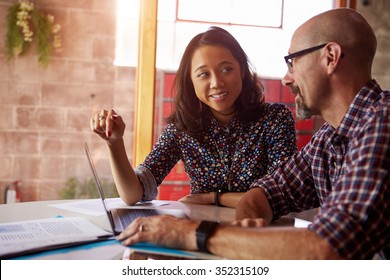 Two Designers With Laptop Meeting In Modern Office