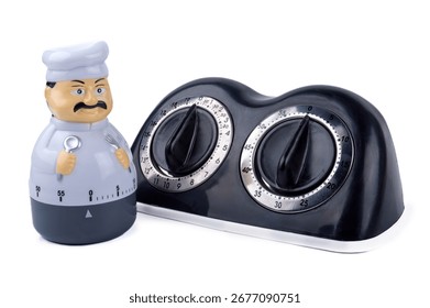 two dial mechanical kitchen timer ticking stopwatch , chef figurine shape cooking timer isolated on white background, black and stainless steel