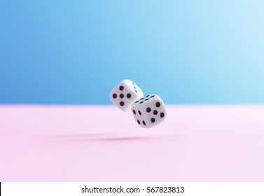 Two Dice Fall Over Pink Background