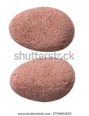 Two different sides of the same stone, isolated on a white background. Close-up of the pebble texture.