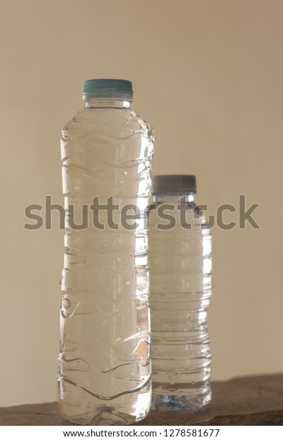 Two different\
size of water plastic\
bottle.