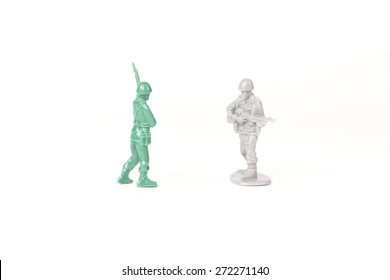 Two Different Toy Army Men Cross Paths