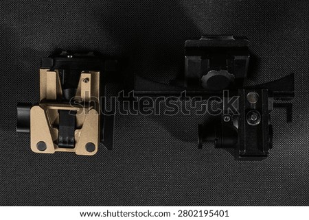 Two different types of tactical night vision device mounts featuring dovetail interface and mini rail adapter on dark background.