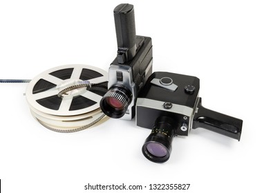 Two Different Vintage Amateur Film Movie Cameras And Reels Of Color Motion Picture Films Super 8mm Format Close-up On A White Background 
