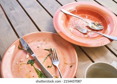 Two Dirty Plate In Outdoor Cafe After Dinner. Messy Dishes Breakfast. Lunch Casual Atmosphere. Lifestyle Cozy Morning. No People. Knife And Fork, Spoon. Nobody Leftover