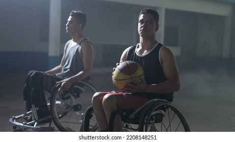 Two Disabled Hispanic Basketball Players In Wheelchairs. Portrait Of A Young South American Man Looking At Camera