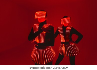 Two  disco dancers move in UV costumes.