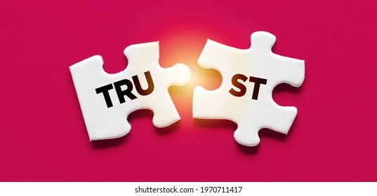 Two Disconnected Puzzle Pieces With The Word Trust. Broken Trust, To Violate Agreements, To Lose Credibility And Reputation Concept.