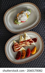 Two dishes, bruschetta with guacamole and poached egg, grilled pita bread with suluguni cheese and tomatoes top view.