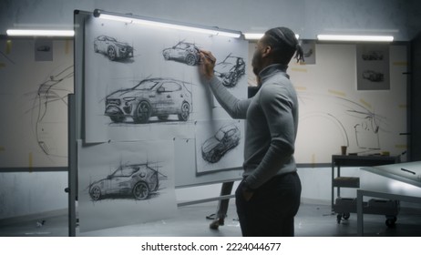 Two diverse automotive male designers drawing sketches with marker on whiteboards, developing futuristic electric car design. They working in modern car design development studio. - Powered by Shutterstock