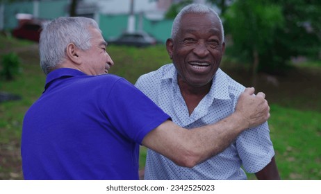 Two diverse Brazilian senior Friends Share Warm Embrace in Park. Old Age Friendship of elderly people Hugging, Displaying Camaraderie - Powered by Shutterstock