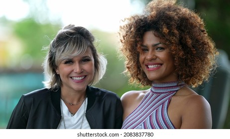 Two Diverse Brazilian Women Standing Outside Looking At Camera