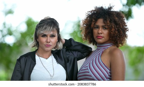 Two Diverse Brazilian Women Standing Outside Looking At Camera