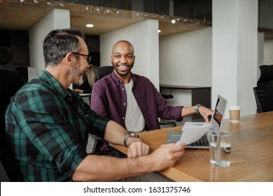 Two Diverse Businessmen Working In Modern Coworking Workspace. Candid Meeting