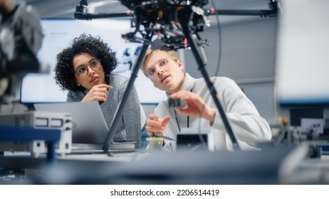 Two Diverse Developers Brainstorming And Programming. Working Together On A New Drone. Colleagues Building, Configuring And Testing Machines. Progressive Technologies Concept.