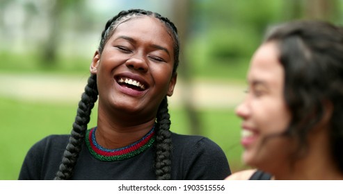 Two Diverse Friends Laughing And Smiling Together. Girlfriends Talking In Conversation Outside. Authentic Real Life Laugh And Smile