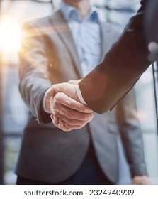 Two diverse professional business men executive leaders shaking hands at office meeting - Shutterstock ID 2324940939