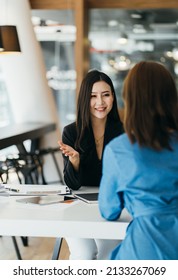 Two Diverse Serious Businesswomen Discussing Business Project Working Together In Office, Serious Female Advisor And Client Talking At Meeting, Focused Executive Colleagues Brainstorm Sharing Ideas