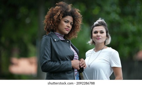 Two Diverse Women Standing Outside In Street. Two Friends Hanging Together