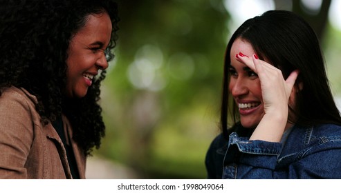 Two Diverse Young Women Chatting In Conversation Outside