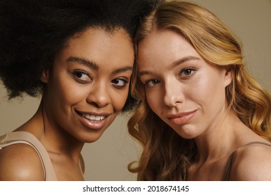 Two Diverse Young Women In Underwear Standing Over Beige Background Close Up