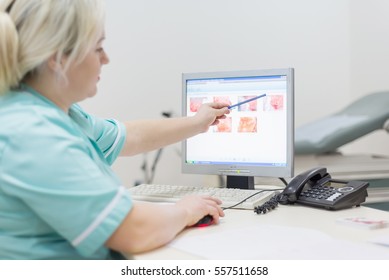 Two doctor female - discussing test reports that show on their screen