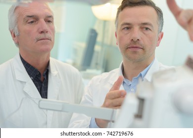 Two Doctors Consulting Each Other About Patients Diagnosis