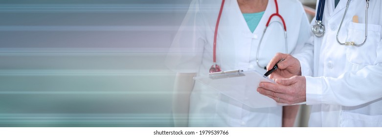 Two doctors discussing about medical report in clinic; panoramic banner - Powered by Shutterstock