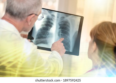 Two doctors examining x-ray report in medical office; multiple exposure