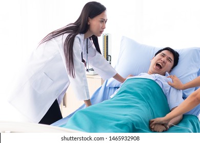 Two Doctors Holding A Psycho Patient On Bed In Hospital