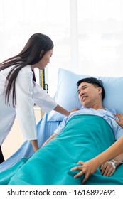 Two Doctors Holding A Psycho Patient On Bed In Hospital