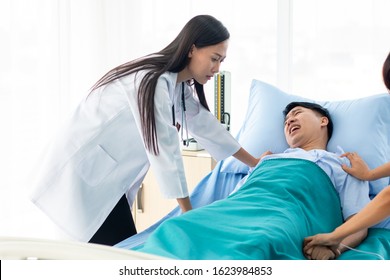 Two Doctors Holding A Psycho Patient On Bed In Hospital