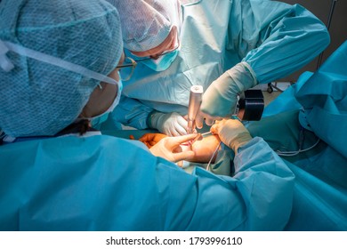 Two Doctors Operate On A Wrist Fracture In An Operating Theatre