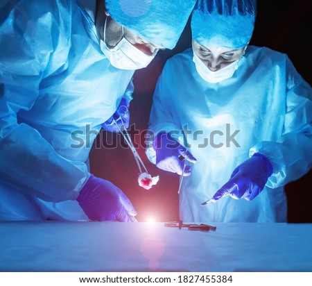 Two doctors perform laser surgery to treat varicose veins and hemorrhoids. Concept laser surgery