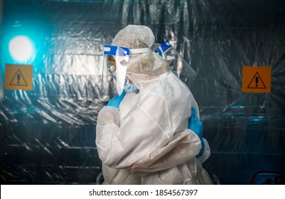 Two Doctors In Protective Suits Hug Each Other. Everything Will Be Fine! Love For Life
