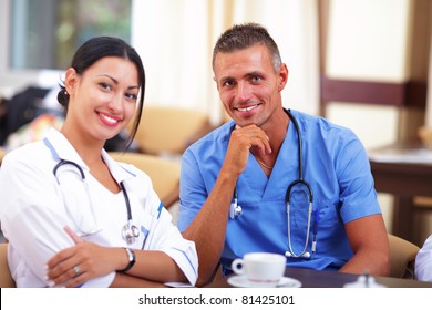 Two Doctors Relaxing In The Staff Room In A Hospital