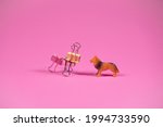 Two dogs on trendy pink background. Kids toy dog and dog made of steel binder clips. Futuristic looking toy. Friends idea. Minimal abstract playing concept.