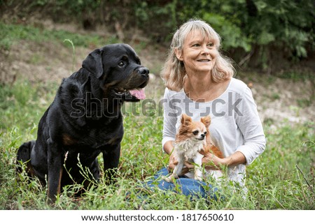 Similar – Image, Stock Photo Blond woman with her two dogs in the countryside