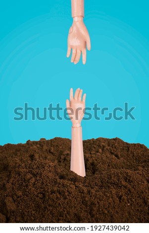 Two doll hands reaching one another. Helping hand minimal concept.