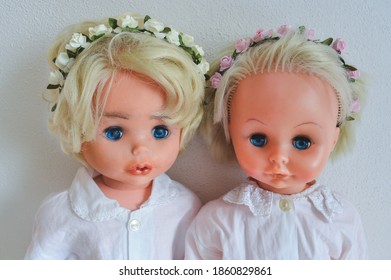 Two Dolls With Blond Hair And Flower Hairband