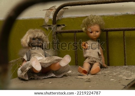 Two dolls over a rusty bed inside an abandonated kinder garden at chernobyl radioactive exclusion zone