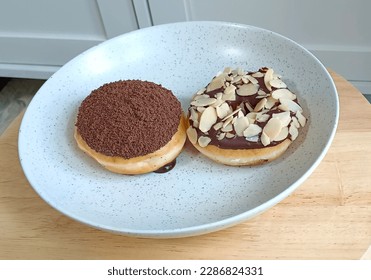 Two donuts on a plate on the table