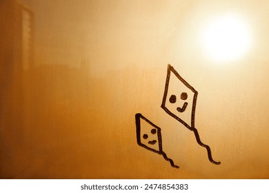 two doodle kite smile face on orange sunset foggy glass window - Powered by Shutterstock