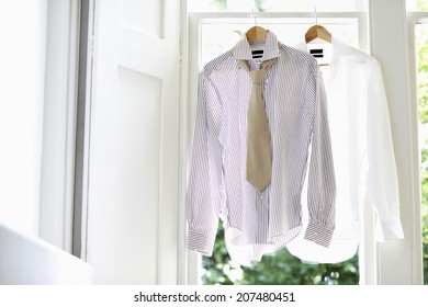 Two Dress Shirts On Hangers At Domestic Window