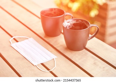 Two Drinking Coffee In Outdoor Cafe After Drink. Messy Cup After Breakfast. Protective Mask. Latte In Mug. Lunch Casual Atmosphere. Lifestyle Cozy Morning. No People