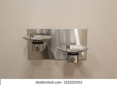 Two Drinking Water Fountains On Wall