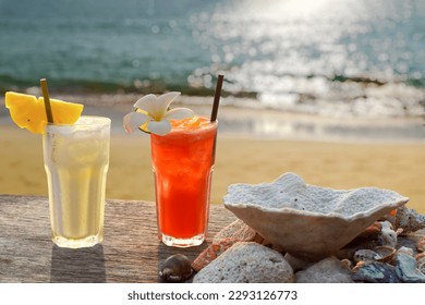 two drinks with a tropical beach in the background
